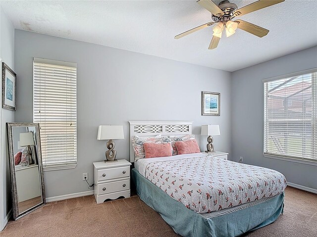 131 Stella Pass, Davenport, FL 33837 - carpeted bedroom with baseboards, a ceiling fan, and a textured ceiling