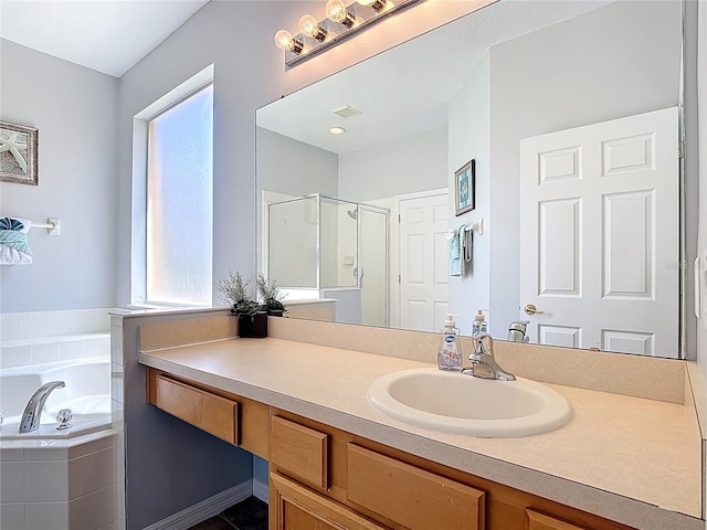 131 Stella Pass, Davenport, FL 33837 - full bath with a stall shower, a garden tub, and vanity