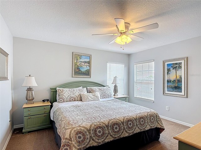 131 Stella Pass, Davenport, FL 33837 - bedroom featuring dark carpet, baseboards, a ceiling fan, and a textured ceiling