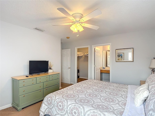 131 Stella Pass, Davenport, FL 33837 - bedroom with carpet flooring, ceiling fan, baseboards, a textured ceiling, and a spacious closet