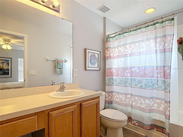 131 Stella Pass, Davenport, FL 33837 - bathroom with toilet, vanity, shower / bath combo, a textured ceiling, and plenty of natural light