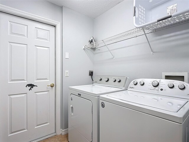 131 Stella Pass, Davenport, FL 33837 - washroom with independent washer and dryer and light tile patterned flooring