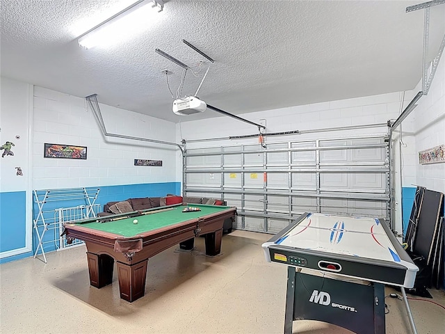 131 Stella Pass, Davenport, FL 33837 - game room featuring concrete block wall, a textured ceiling, billiards table, and a garage