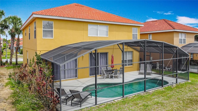 131 Stella Pass, Davenport, FL 33837 - rear view of property with a patio, a tiled roof, an outdoor pool, and stucco siding
