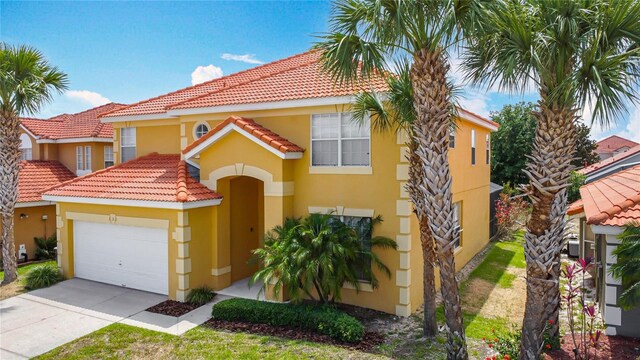 131 Stella Pass, Davenport, FL 33837 - mediterranean / spanish home with stucco siding, a tile roof, a garage, and driveway