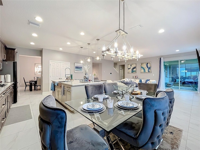 dining area with recessed lighting, visible vents, and a notable chandelier