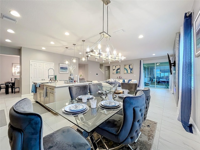 dining room with baseboards, visible vents, a chandelier, and recessed lighting