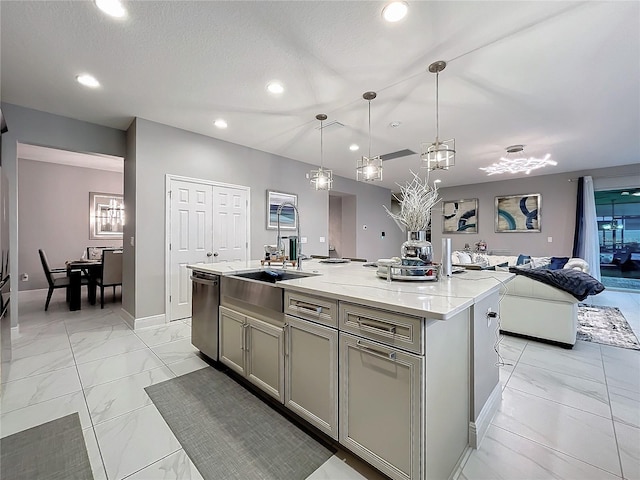 kitchen with marble finish floor, gray cabinets, open floor plan, a kitchen island with sink, and dishwasher