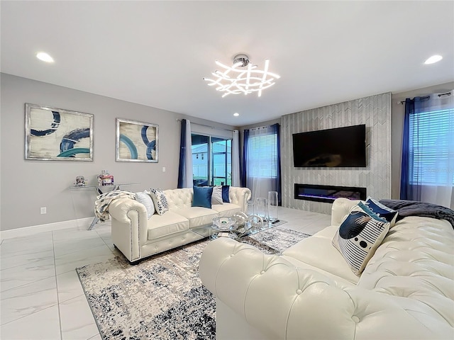 living area with marble finish floor, a healthy amount of sunlight, a fireplace, and baseboards