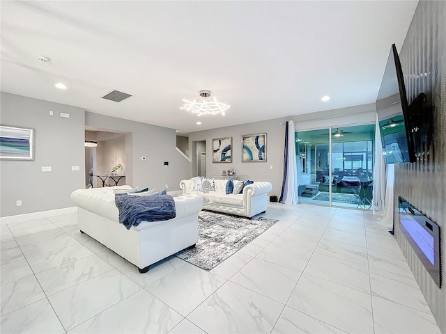 living room featuring recessed lighting, marble finish floor, and baseboards