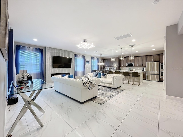 living room featuring recessed lighting and marble finish floor