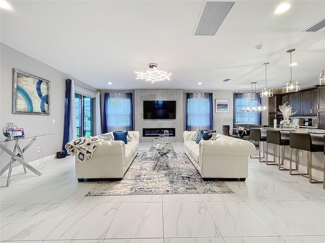 living room featuring recessed lighting, marble finish floor, visible vents, and a notable chandelier