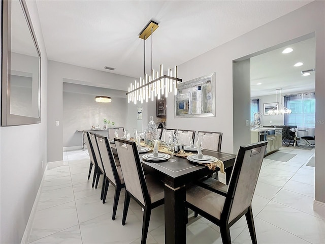 dining area with a notable chandelier, recessed lighting, visible vents, and baseboards