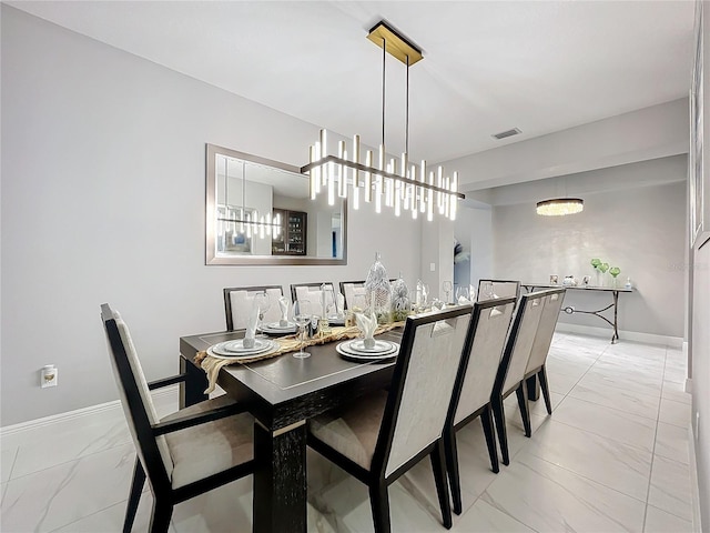 dining area featuring marble finish floor, visible vents, and baseboards