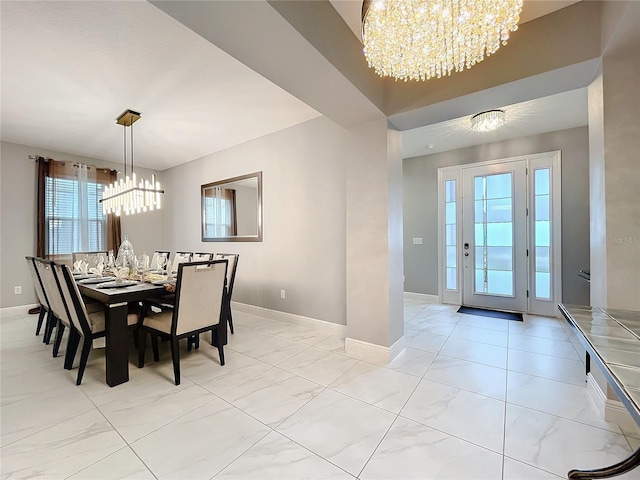 dining space with baseboards and an inviting chandelier