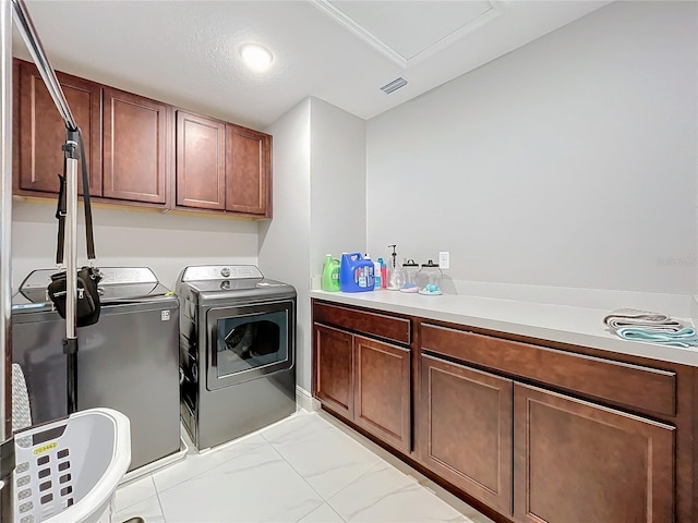 laundry room with marble finish floor, visible vents, cabinet space, and washing machine and clothes dryer