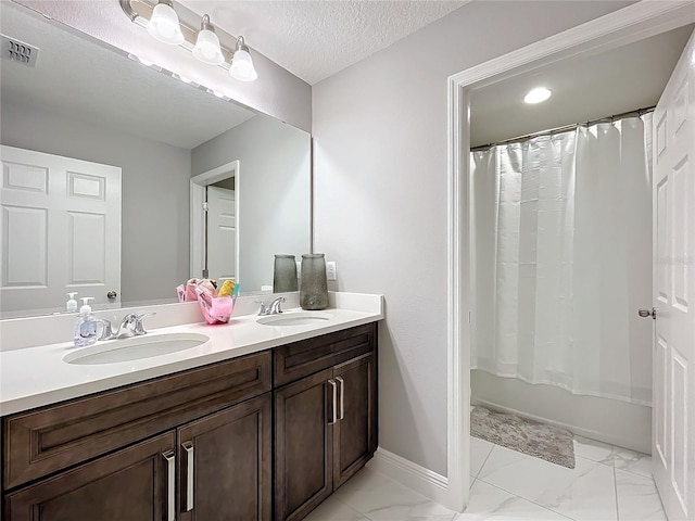 full bath with marble finish floor, a sink, and visible vents