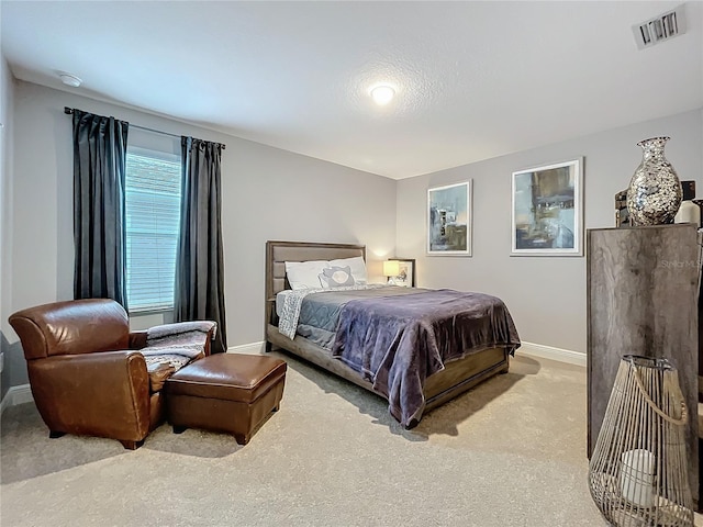 carpeted bedroom with baseboards and visible vents