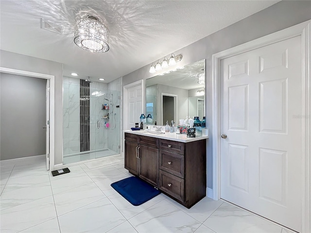 bathroom featuring a textured ceiling, vanity, visible vents, marble finish floor, and a shower stall