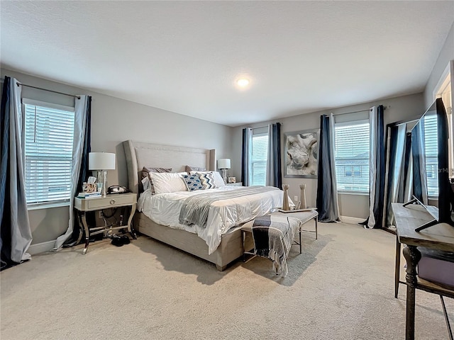 carpeted bedroom featuring baseboards