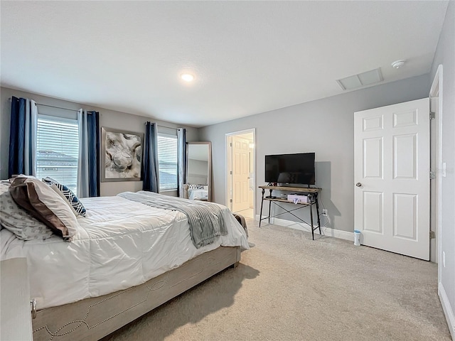 bedroom with multiple windows, carpet flooring, and baseboards