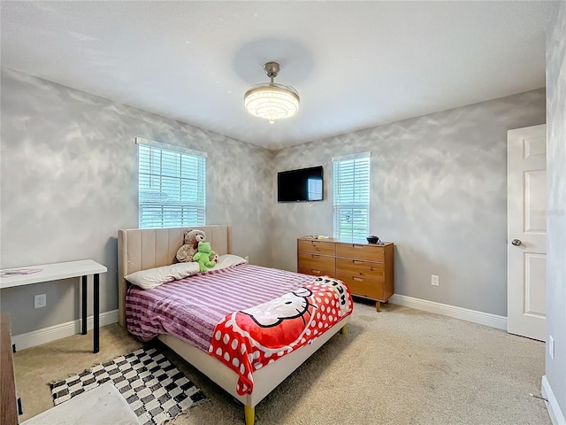 carpeted bedroom with baseboards