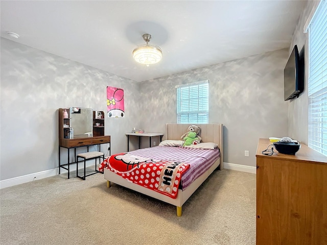 carpeted bedroom featuring baseboards