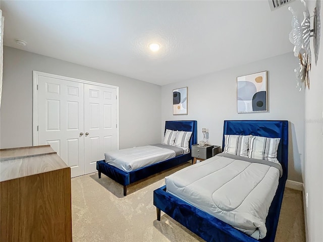 bedroom with carpet floors, a closet, and visible vents