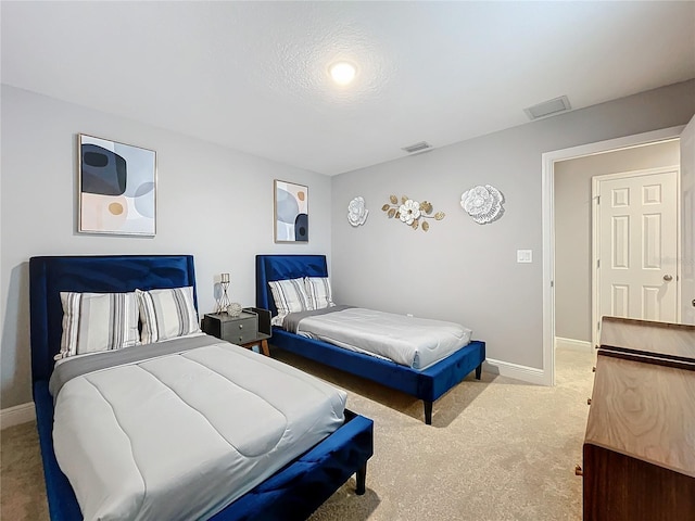 carpeted bedroom featuring visible vents and baseboards