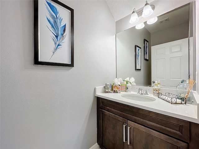 bathroom featuring visible vents and vanity