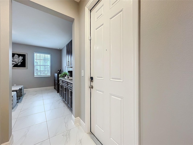 interior space with marble finish floor and baseboards