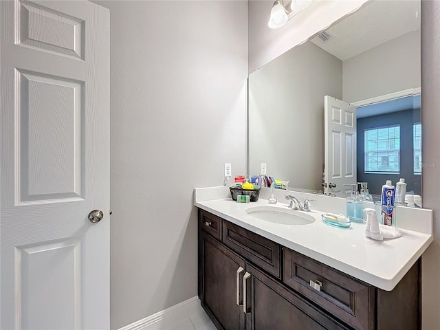 bathroom with visible vents, vanity, and baseboards