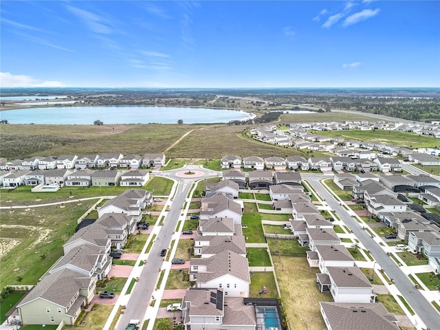 birds eye view of property with a water view and a residential view