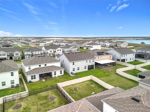 drone / aerial view featuring a water view and a residential view