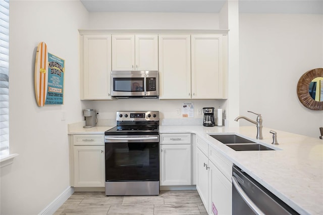 8012 Lost Shaker Ln, Kissimmee, FL 34747 - kitchen featuring appliances with stainless steel finishes, white cabinetry, baseboards, and a sink