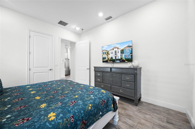 8012 Lost Shaker Ln, Kissimmee, FL 34747 - bedroom featuring visible vents, baseboards, and wood finished floors