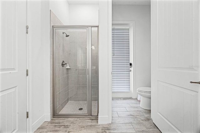 8012 Lost Shaker Ln, Kissimmee, FL 34747 - bathroom with a stall shower, toilet, and baseboards