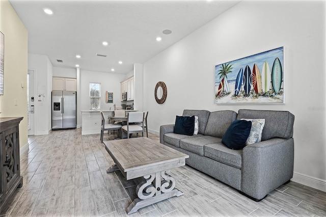 8012 Lost Shaker Ln, Kissimmee, FL 34747 - living room featuring recessed lighting, visible vents, baseboards, and wood tiled floor