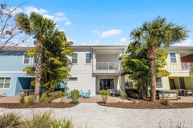 8012 Lost Shaker Ln, Kissimmee, FL 34747 - view of front of property featuring stucco siding, a balcony, board and batten siding, and a patio area