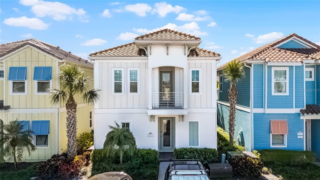 8012 Lost Shaker Ln, Kissimmee, FL 34747 - view of front of house featuring a balcony, board and batten siding, and a tiled roof