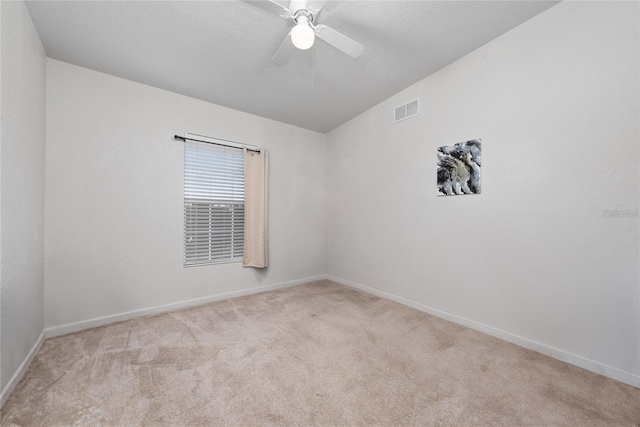 unfurnished room featuring light colored carpet, visible vents, ceiling fan, and baseboards