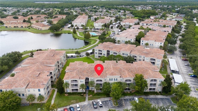 birds eye view of property with a water view and a residential view