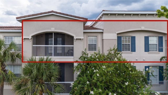 view of front of property with a tiled roof and stucco siding