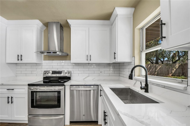 628 Eastwood Ct, Altamonte Springs, FL 32714 - kitchen with stainless steel appliances, white cabinetry, a sink, light stone countertops, and wall chimney exhaust hood