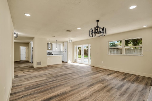628 Eastwood Ct, Altamonte Springs, FL 32714 - unfurnished living room featuring light wood-style floors, recessed lighting, french doors, and visible vents