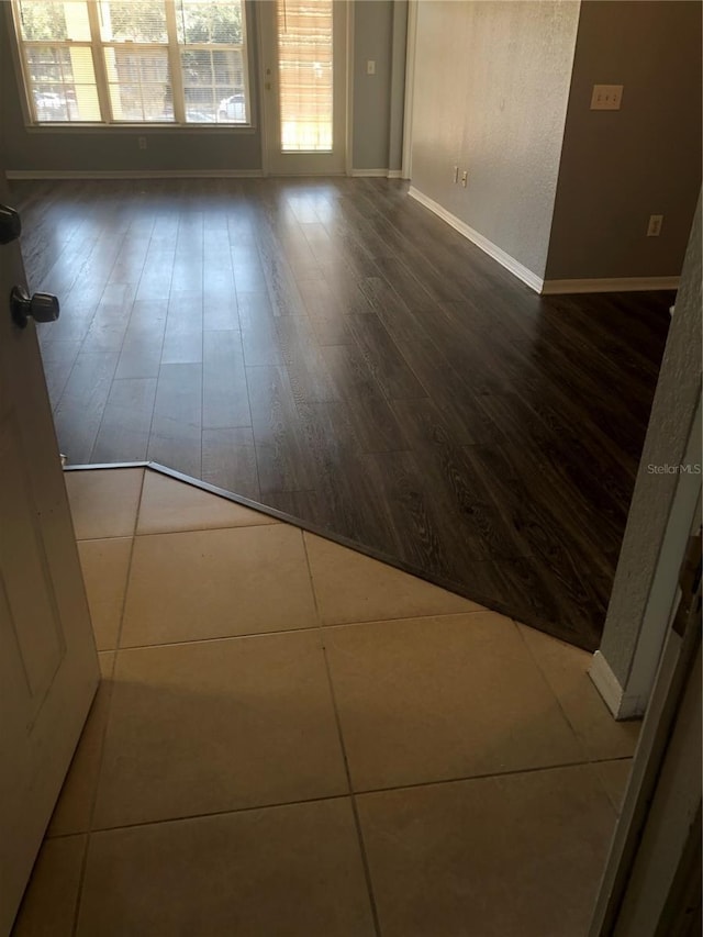 empty room featuring dark wood-style floors and baseboards