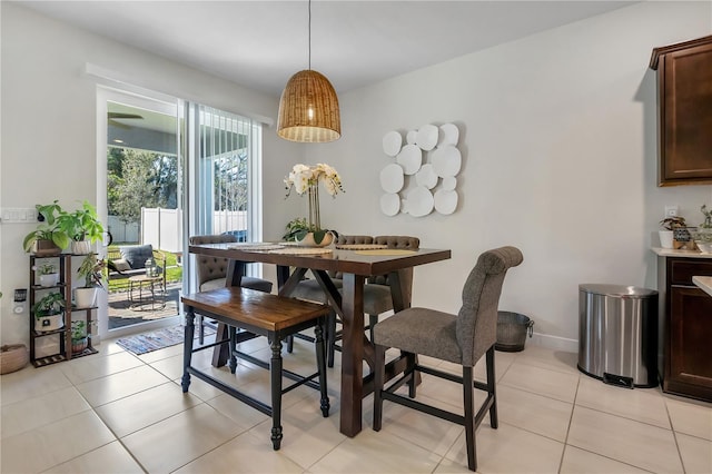 dining area featuring light tile patterned flooring and baseboards