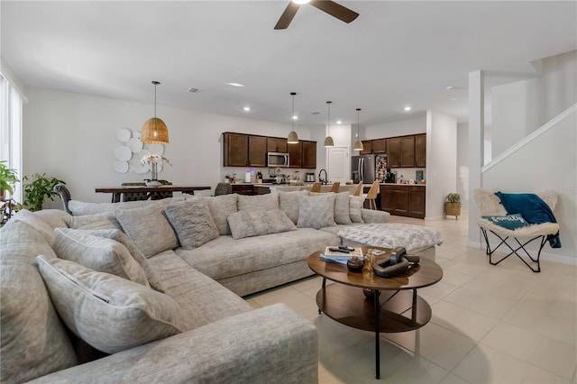 living area featuring light tile patterned floors, baseboards, a ceiling fan, and recessed lighting