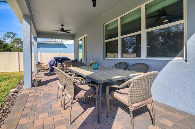 view of patio with a fenced backyard, outdoor dining area, and a ceiling fan