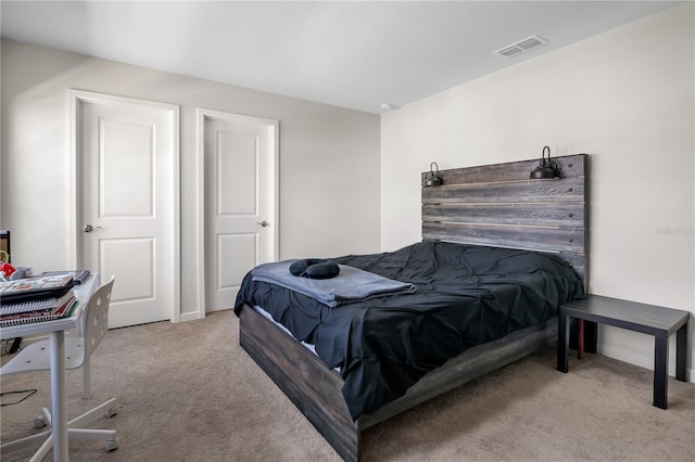 bedroom with light carpet and visible vents